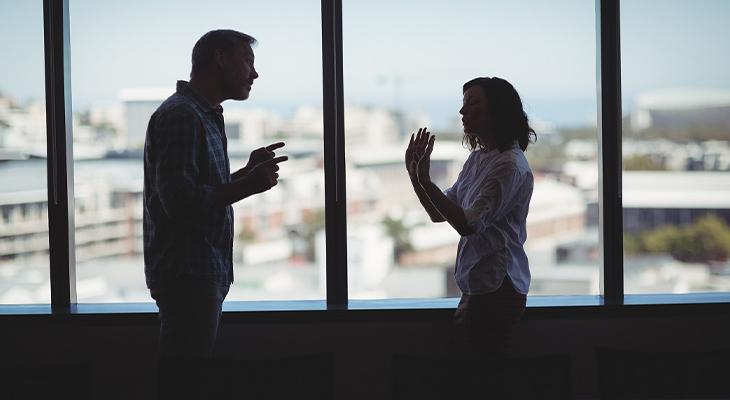 man and woman arguing, potentially uttering threats